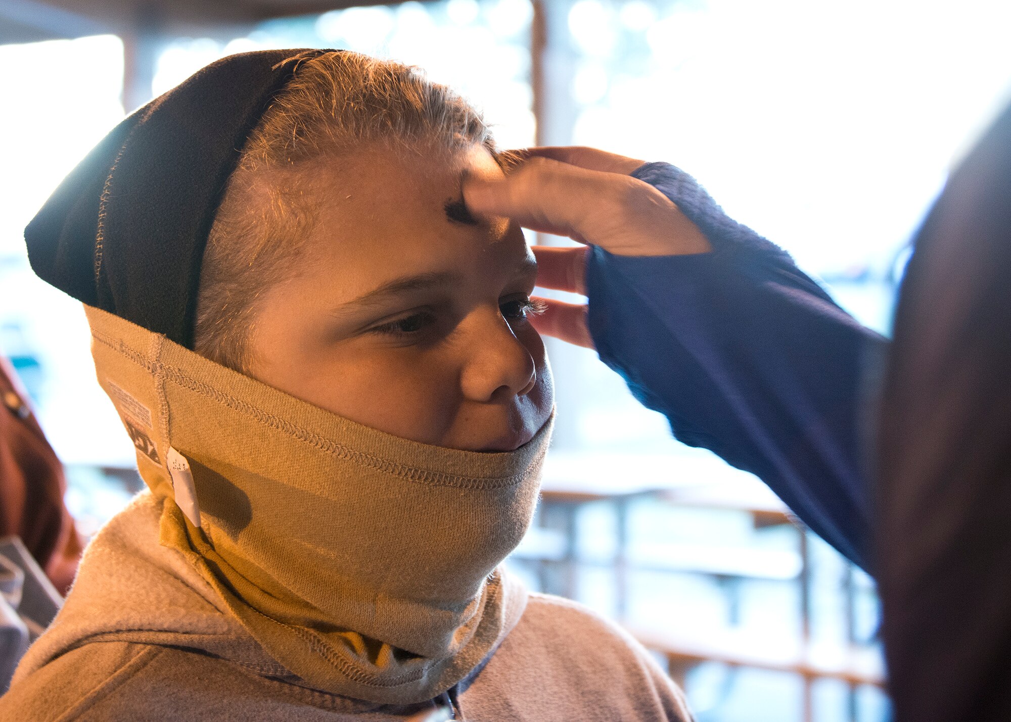Thomas Leachman, 12, receives an optional little black cross of ashes from a 96th Test Wing Chaplain during the Ashes to Dust 5K Feb. 18 at the Civil Engineering Pavilion on Eglin Air Force Base, Fla.  Approximately 225 runners came out for the Ash Wednesday, Ashes to Dust 5K run.  Ash Wednesday marks the beginning of the Lent season for Christians so  Eglin’s Chapel held the event to start the season with spiritual and physical inspiration.  (U.S. Air Force photo/Ilka Cole)