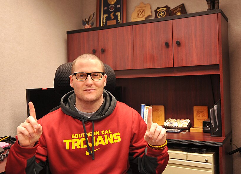 Staff Sgt. Andy Moore, 319th Air Base Wing Command Post, NCO-in-charge of command post systems, sports University of Southern California gear while checking his email during his day off Feb. 23, 2015 on Grand Forks Air Force Base, N.D. Moore was recently admitted into the prestigious Sol Price of Public Policy for the Master of Public Administration program. The school is rated the number five in the United States for its MPA program with only a seven percent acceptance rate. (U.S. Air Force photo/Airman 1st Class Bonnie Grantham)