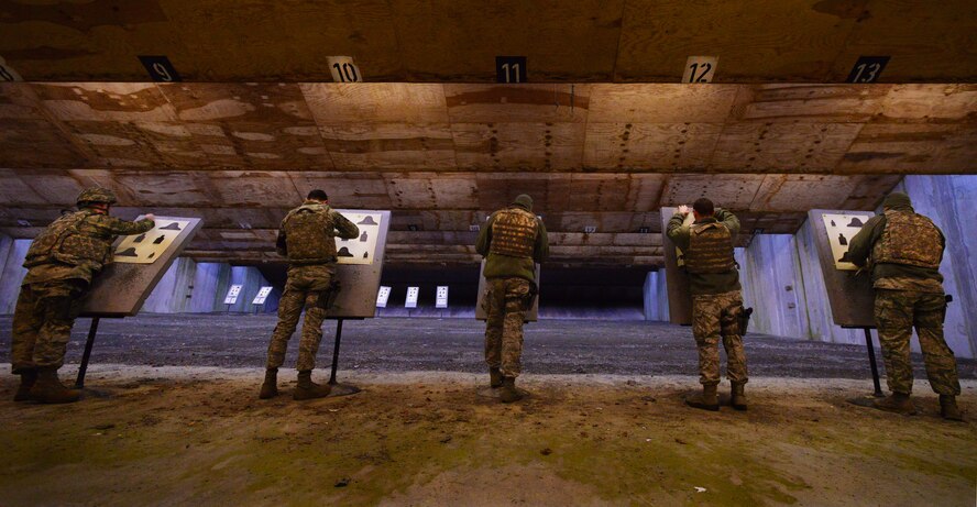 Airmen move their targets down-range during an M-4 carbine qualification test at the Kaiserslautern Military Community Combat Arms Training and Maintenance firing range, Vogelweh Military Complex, Germany, Feb. 19, 2015. CATM instructors qualify more than 7,000 students annually. (U.S. Air Force photo/Senior Airman Nicole Sikorski)