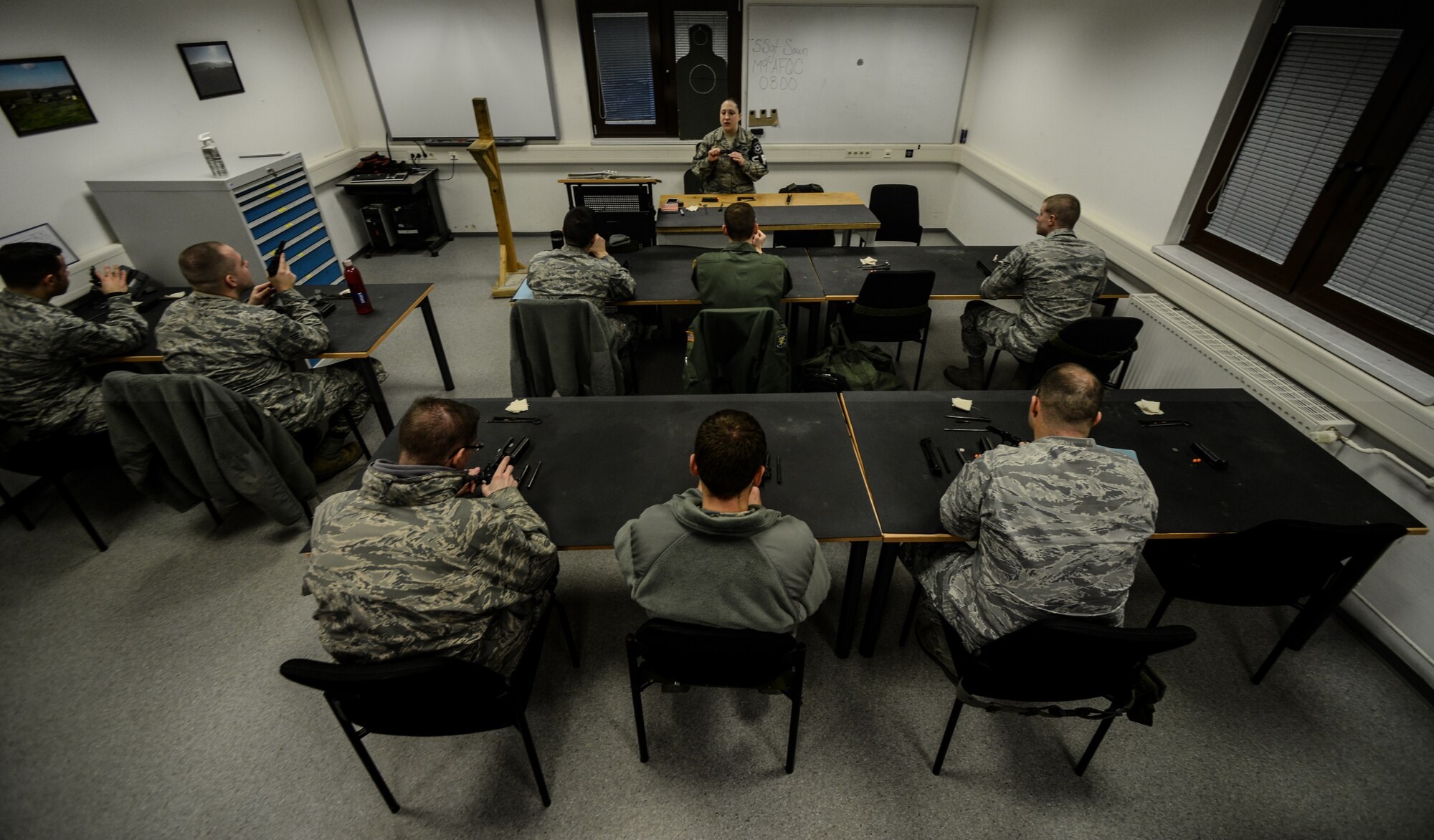 Staff Sgt. Kellie Sawn, 569th Combat Arms Training and Maintenance instructor, teaches a class on proper procedures when firing an M-9 pistol at the Kaiserslautern Military Community Combat Arms Training and Maintenance firing range, Vogelweh Military Complex, Germany, Feb. 19, 2015. The KMC CATM is the second busiest CATM facility in the Air Force next to Lackland Air Force Base, Texas. (U.S. Air Force photo/Senior Airman Nicole Sikorski)