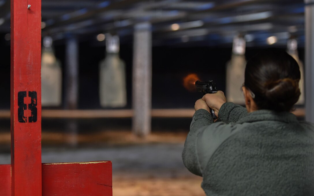 Staff Sgt. Amanda Alejandro, 11th Security Forces Squadron response force leader, shoots an M9 pistol at the firing range on Joint Base Andrews, Md., Feb. 3, 2015. Shooters must score 35 to pass the M9 qualification course. (U.S. Air Force photo/Airman 1st Class Philip Bryant)