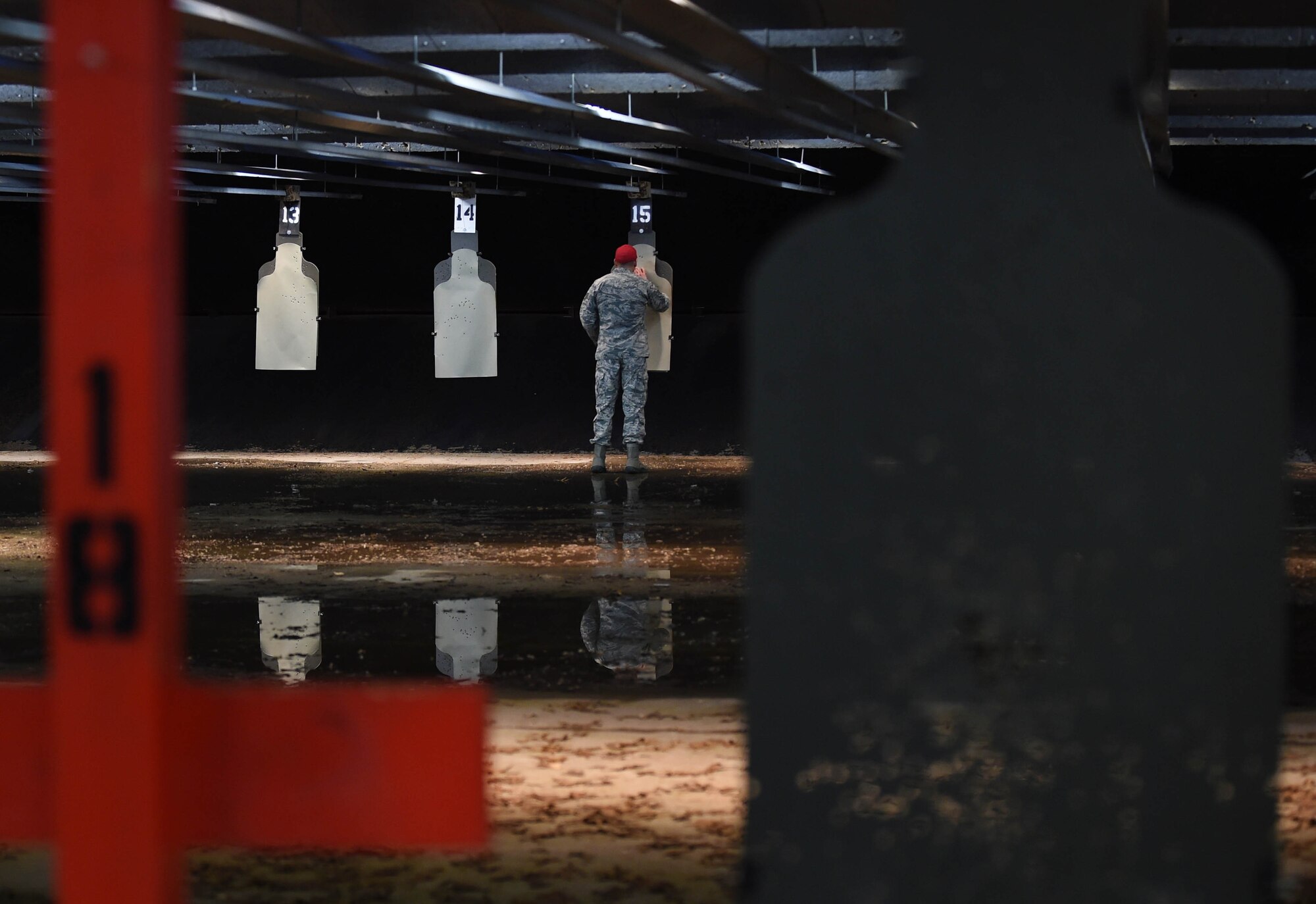 Staff Sgt. Juan Garcia, Combat Arms instructor, tallies bullet holes on the targets at the firing range on Joint Base Andrews, Md., Feb. 3, 2015. Garcia is certified to teach the M4, M9, M11, M870, M24B, M2409 and the MP5 firearms. (U.S. Air Force photo/Airman 1st Class Philip Bryant)