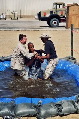 (Then) Capt. Matthew Boyd (left) baptizes a service member during a deployment to the Middle East in 2009. Now a major, Boyd continues his long lineage of serving in the military as a chaplain offering guidance and contentment for those in need. (Courtesy photo)