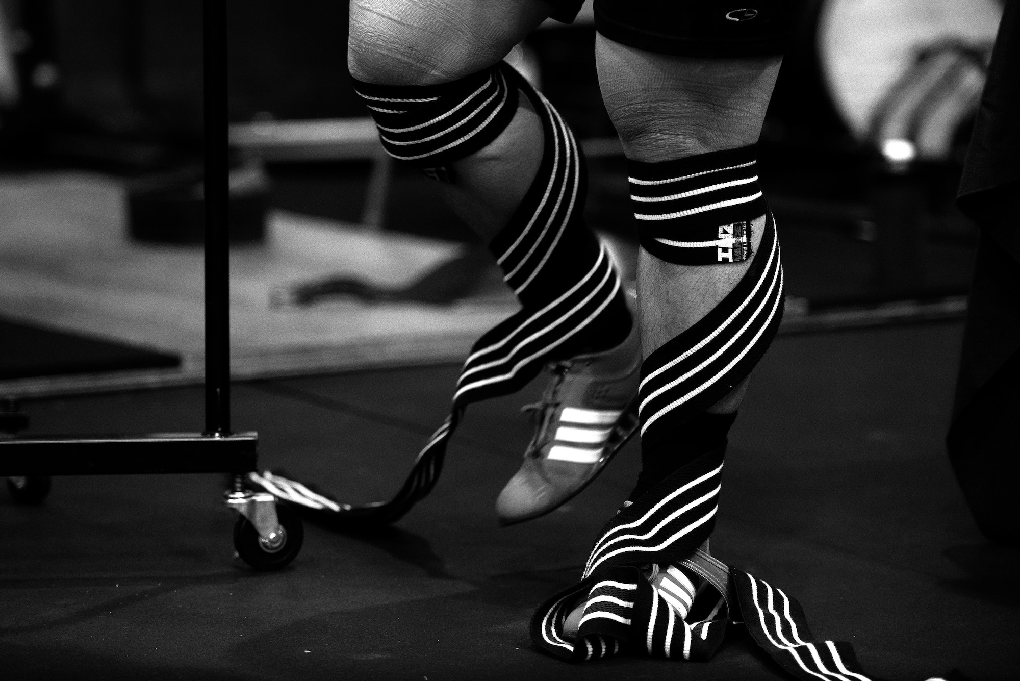 Ron Yim, event competitor, loosens his knee straps in the 2015 Yokota Powerlifting Invitational held in the Samurai Fitness Center at Yokota Air Base, Japan, Feb. 21, 2015. Yokota plans to host competitive powerlifting competitions annually. (U.S. Air Force photo by Airman 1st Class Delano Scott/Released)