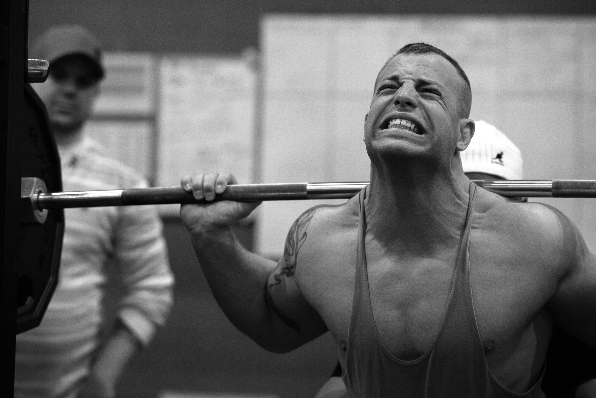 U.S. Air Force Staff Sgt. Joseph Lafaille, event competitor, performs a squat in the 2015 Yokota Powerlifting Invitational held in the Samurai Fitness Center at Yokota Air Base, Japan, Feb. 21, 2015. The invitational judged the abilities of Lafaille and his competitors in the bench press, deadlift and squat exercises. (U.S. Air Force photo by Airman 1st Class Delano Scott/Released)
