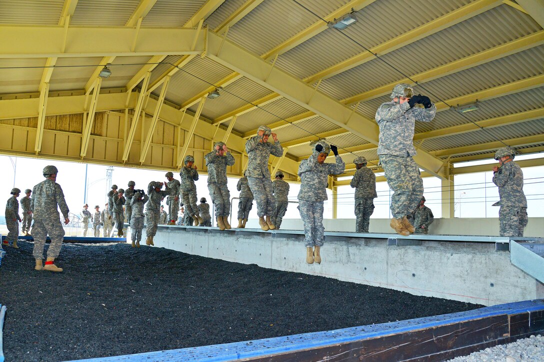 U.S. Army paratroopers pratice parachute landing falls on Aviano Air Base, Italy, before conducting an airborne operation on Juliet drop zone in Pordenone, Italy, Feb. 19, 2015.