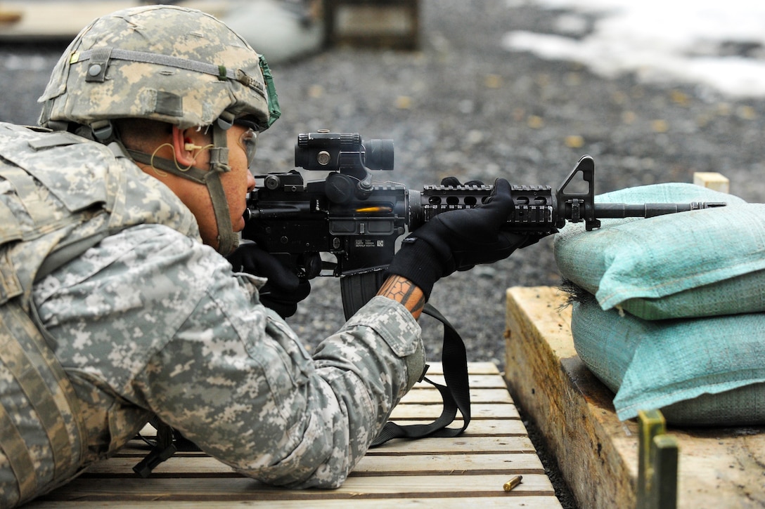 U.S. Army Spc. Soane Posoa fires his weapon before a qualification ...