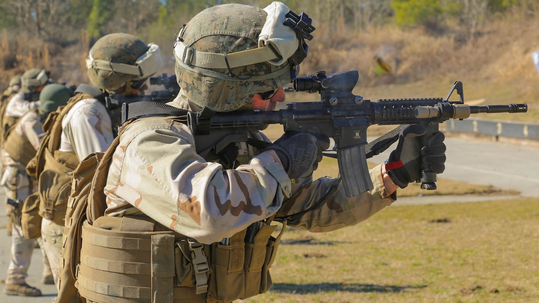 A Marine with 2nd Combat Engineer Battalion, 2nd Marine Division, fires an M4 carbine rifle at a range here, Feb. 10, 2015. Critical Skills Operators with 3rd Marine Special Operations Battalion, U.S. Marine Corps Forces Special Operations Command, trained with 2nd CEB Marines during RAVEN 15-03, a 10-day realistic military training exercise to enhance 3rd MSOB’s readiness for worldwide support to global security. Marines with 2nd CEB played the role of a partner nation force during the exercise.
