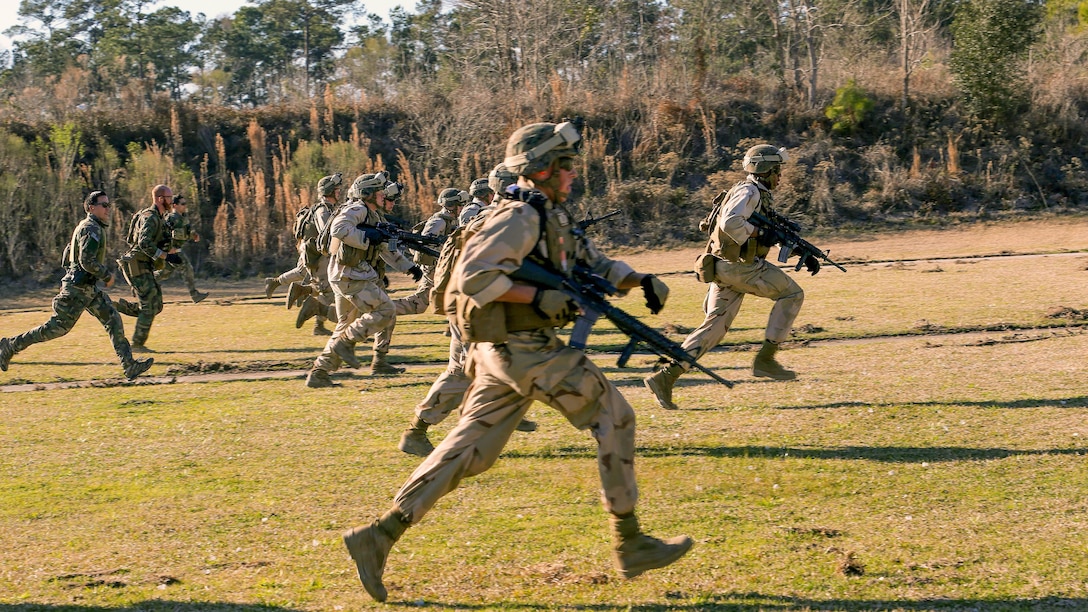Marines with 2nd Combat Engineer Battalion, 2nd Marine Division, run to a firing point at a range here, Feb. 10, 2015. Critical Skills Operators with 3rd Marine Special Operations Battalion, U.S. Marine Corps Forces Special Operations Command, trained with 2nd CEB Marines during RAVEN 15-03, a 10-day realistic military training exercise to enhance the battalion’s readiness for worldwide support to global security. Marines with 2nd CEB played the role of a partner nation force during the exercise.