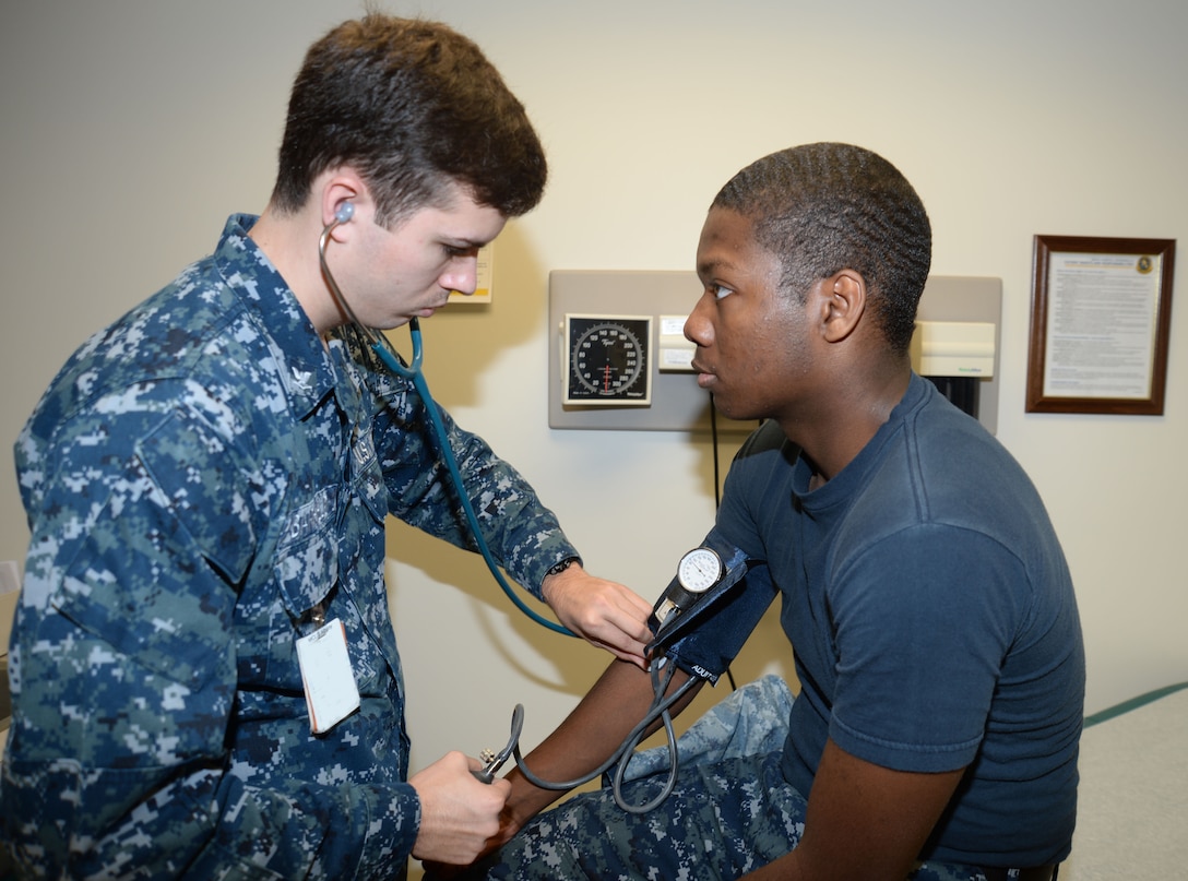 In recognition of American Heart Month, HM3 Bryce Barfield, general corpsman, performs a blood pressure check on fellow hospital general corpsman, HN Christopher Mincey, recently. Both sailors are active-duty members in Primary Care, Naval Branch Health Clinic, Marine Corps Logistics Base Albany.
