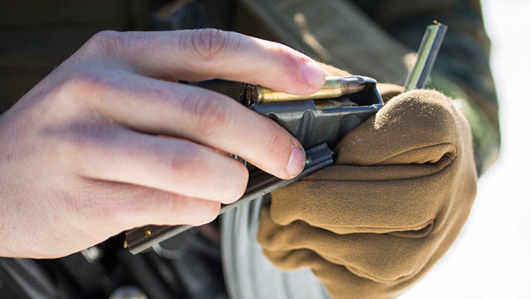 U.S. Marine Corps Pfc. William K. Finn, rifleman, Alpha Company, 1st Battalion, 8th Marine Regiment, 2nd Marine Division, loads 5.56 mm Brass Blank Ammunition into a magazine prior to conducting a two kilometer patrol during a Deployment for Training exercise on Marine Corps Base Quantico, Va., Feb. 18, 2015. The exercise focused on stability operations and various training missions.