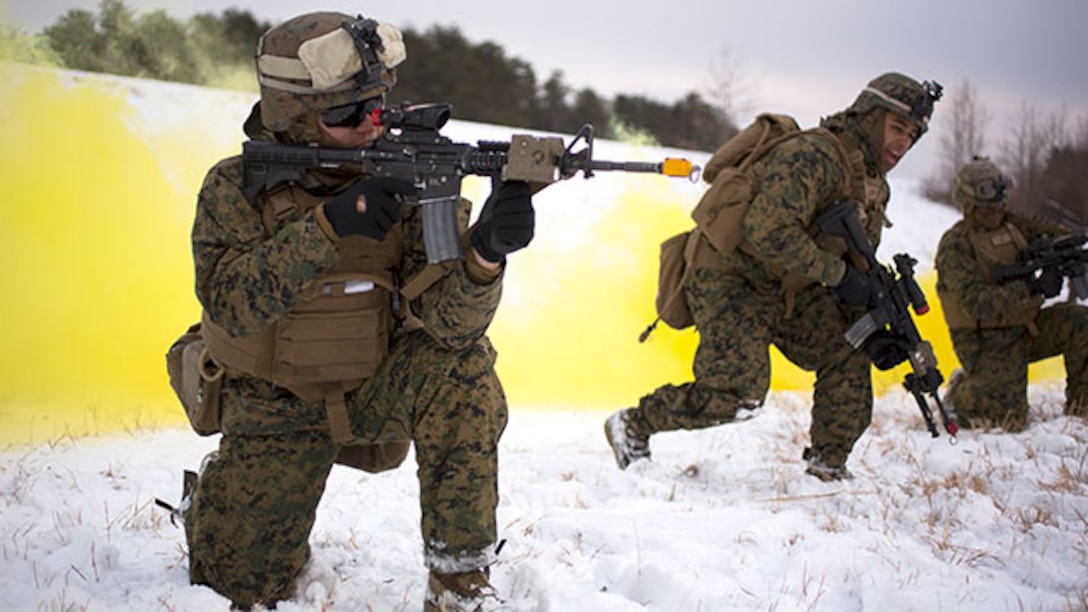 U.S. Marine Corps Lance Cpl. Didier Burbano, left, team leader, lays simulated suppressive fire down range for his fire team member, Lance Cpl. Michael I. Solano, right, infantry automatic rifleman, both with Alpha Company, 1st Battalion, 8th Marine Regiment, 2nd Marine Division (MARDIV), as they preform fire and maneuver drill across during a Deployment for Training exercise on Marine Corps Base Quantico, Va., Feb. 18, 2015. The exercise focused on stability operations and various training missions.