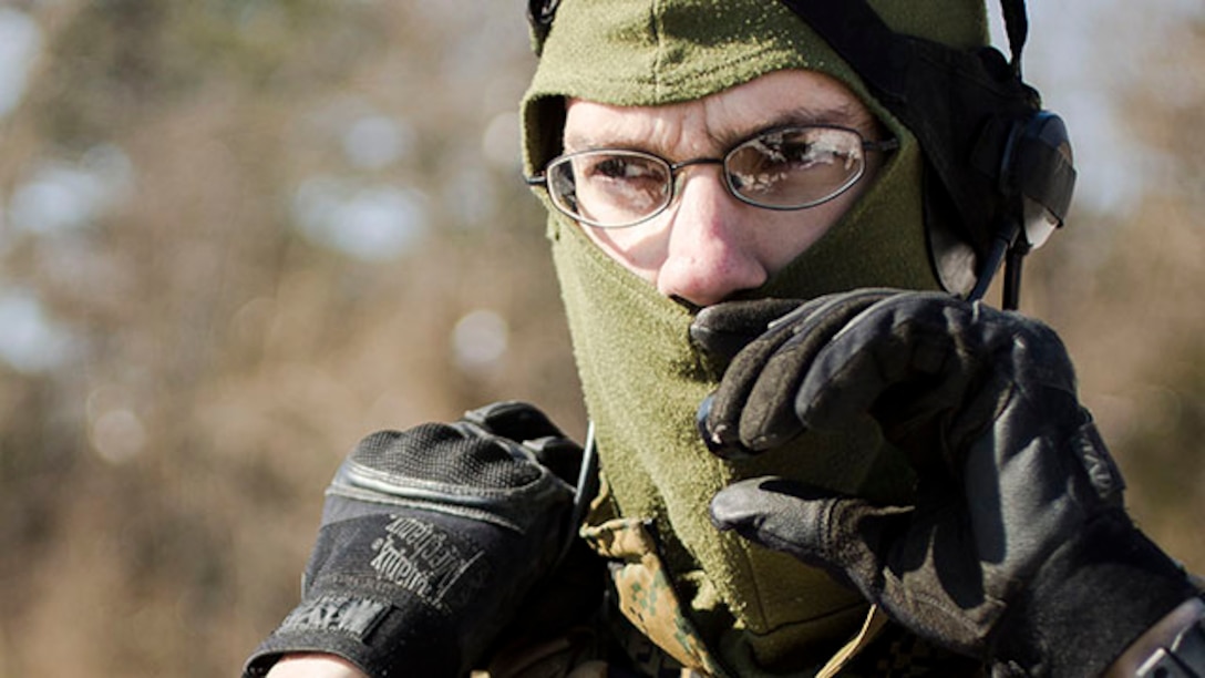 U.S. Marine Corps Sgt. Maxwell E. Wrede, squad leader, Alpha Company, 1st Battalion, 8th Marine Regiment, 2nd Marine Division, adjusts his headset prior to conducting a two kilometer patrol during a Deployment for Training exercise on Marine Corps Base Quantico, Va., Feb. 18, 2015. The exercise which focused on stability operations and various training missions.