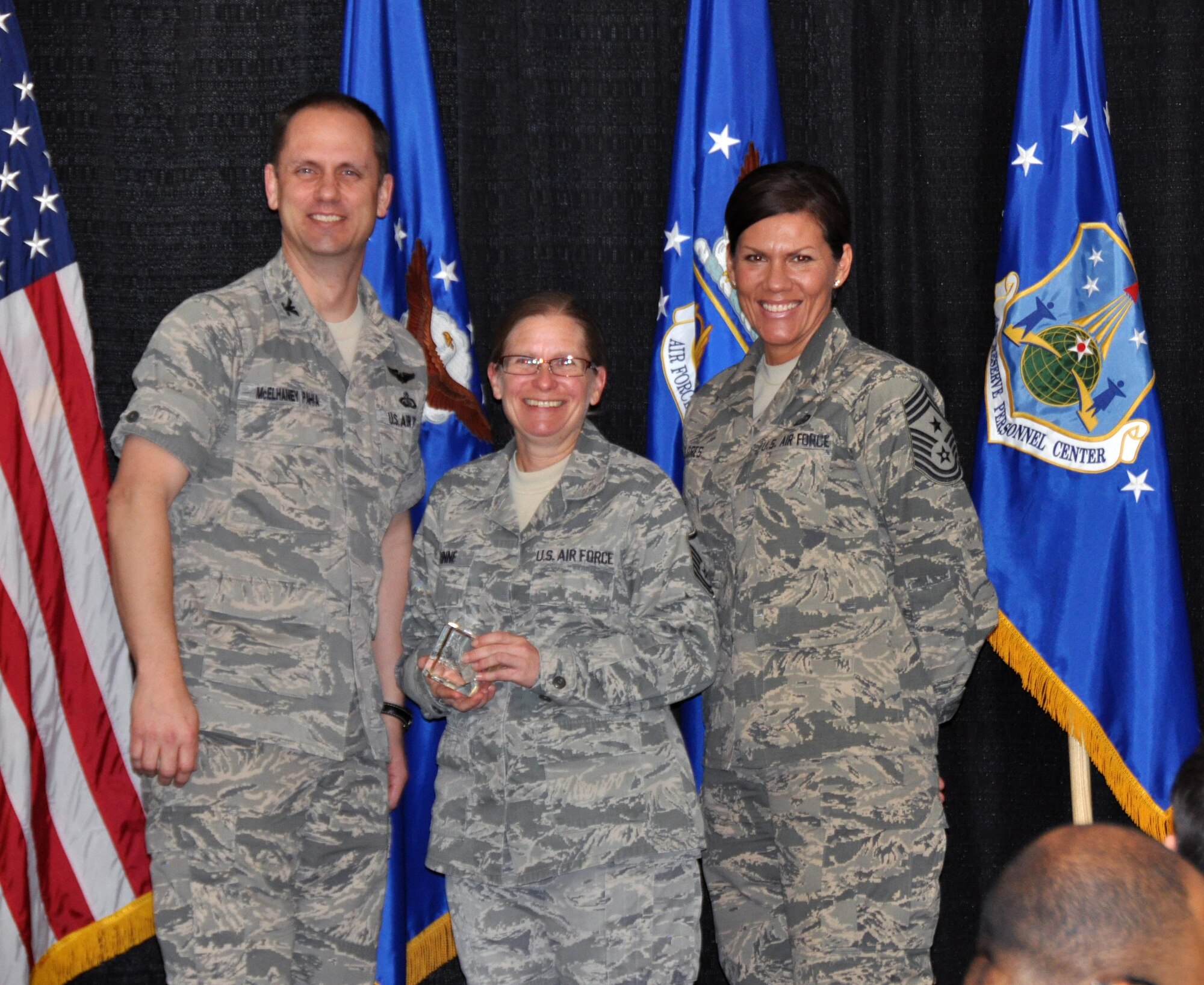 Col. Sean McElhaney Pahia, Air Reserve Personnel Center vice commander, and Chief Master Sgt. Ruthe Flores, ARPC command chief, present the Dr. Edwin C. Peterson Education and Training Manager Award to Master Sgt. Jacqueline Rinne. McElhaney Pahia honored ARPC’s 2014 outstanding performers of the year as well as their A1 annual award winners at the Summit Conference and Event Center Feb. 24, 2015, in Denver. (U.S. Air Force photo/Tech. Sgt. Rob Hazelett)