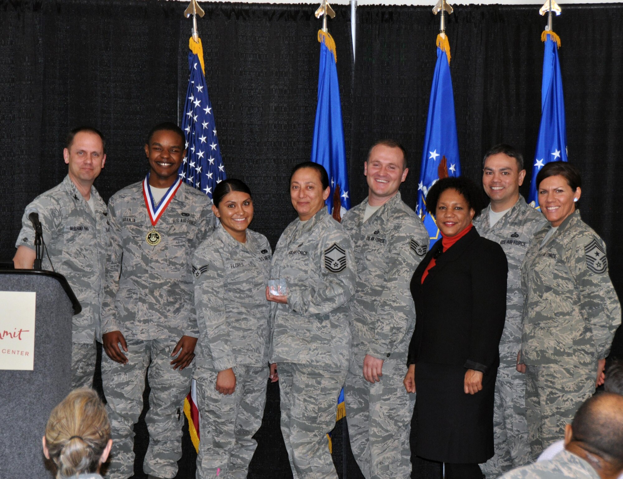 Col. Sean McElhaney Pahia, Air Reserve Personnel Center vice commander, and Chief Master Sgt. Ruthe Flores, ARPC command chief, present the ARPC Team of the Year award to members from the Special Pay and Initiatives team. McElhaney Pahia honored ARPC’s 2014 outstanding performers of the year as well as their A1 annual award winners at the Summit Conference and Event Center Feb. 24, 2015, in Denver. (U.S. Air Force photo/Tech. Sgt. Rob Hazelett)