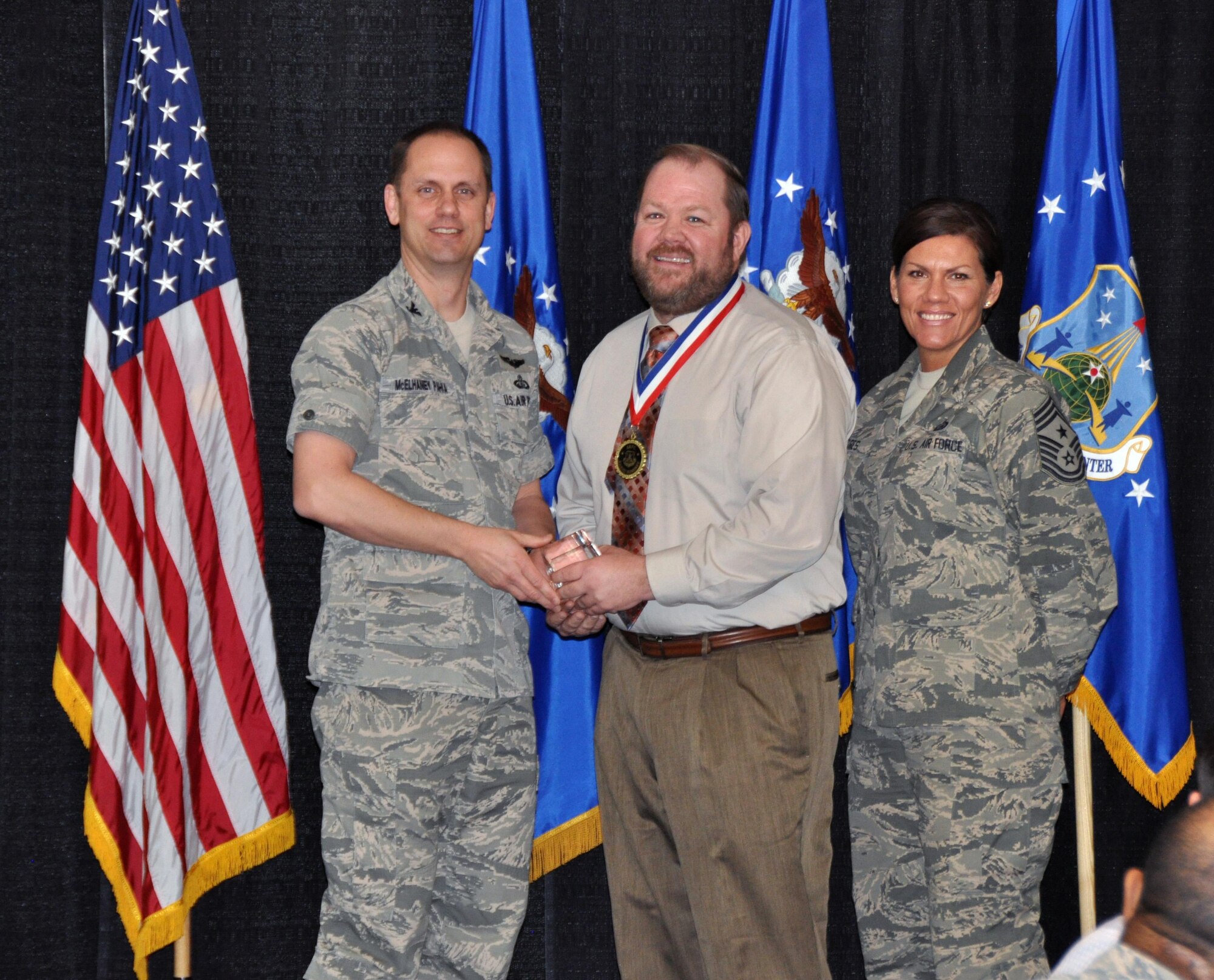 Col. Sean McElhaney Pahia, Air Reserve Personnel Center vice commander, and Chief Master Sgt. Ruthe Flores, ARPC command chief, present the A1 Civilian Specialist of the Year, Operational Level award to Gary Thurman. McElhaney Pahia honored ARPC’s 2014 outstanding performers of the year as well as their A1 annual award winners at the Summit Conference and Event Center Feb. 24, 2015, in Denver. (U.S. Air Force photo/Tech. Sgt. Rob Hazelett)