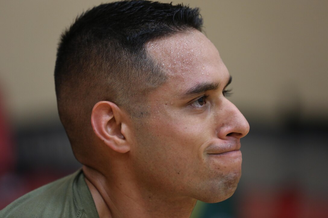 A Marine prepares for an overhead squat with a weighted barbell during a High Intensity Tactical Training instructor certification course at Hopkins Hall Gym at Camp Allen in Norfolk, Virginia. Feb. 10. Emphasis of the HITT program is on key components with relation to superior speed, power, strength endurance and overall combat readiness while reducing the likelihood of injury and ensuring that all Marines are physically prepared for combat.  