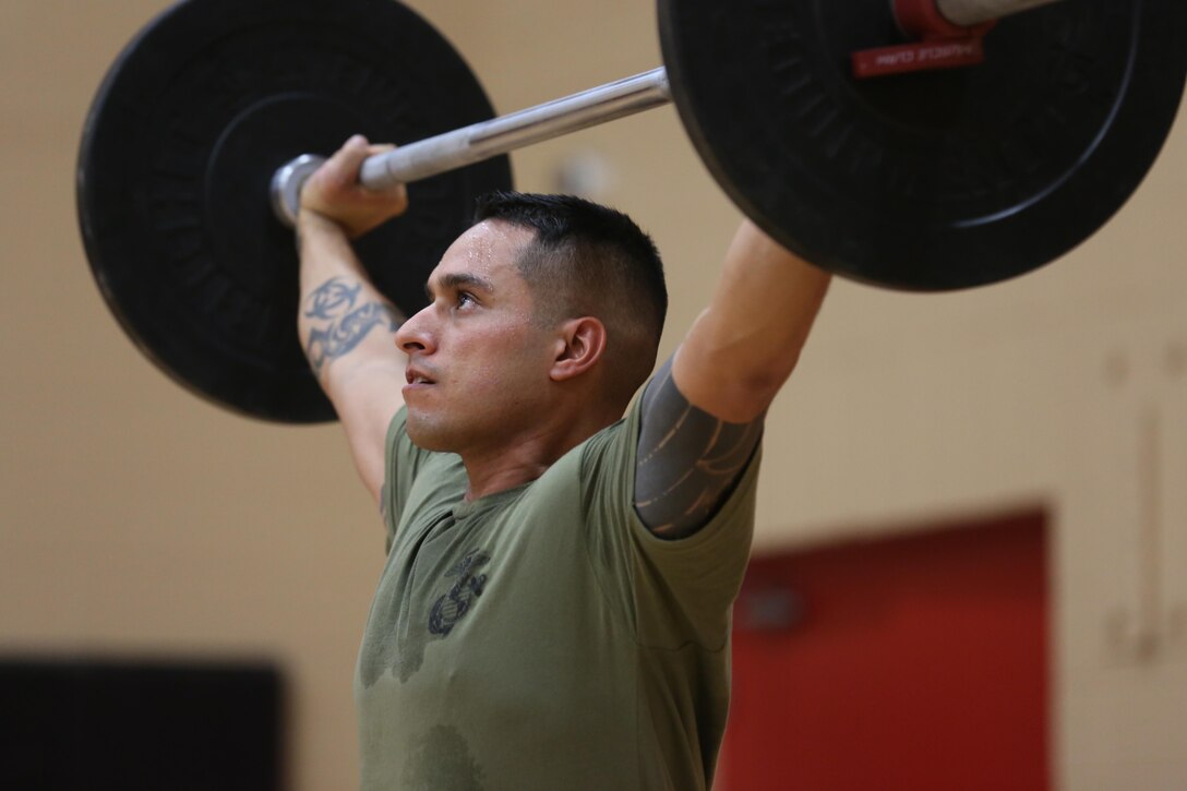 A Marine practices the snatch exercise during the High Intensity Tactical Training certification course at Hopkins Hall Gym at Camp Allen in Norfolk, Virginia, Feb 10.Nearly 25 Marines attended the course to become certified HITT instructors to incorporate into their unit's daily physical training.The course teaches Marines how to properly and effectively instruct exercises associated with the three modules of HITT: Combat, Warrior and Athlete HITT.