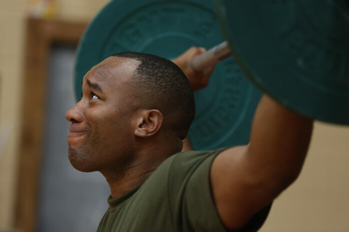 A Marine focuses on proper form during an overhead squat during a High Intensity Tactical Training certification course at Hopkins Hall Gym at Camp Allen, in Norfolk, Virginia, Feb. 10. Nearly 25 Marines attended the course to incorporate this training into their units' physical training. The course teaches Marines how to properly and effectively instruct exercises associated with the three modules of HITT: Combat, Warrior and Athlete HITT.