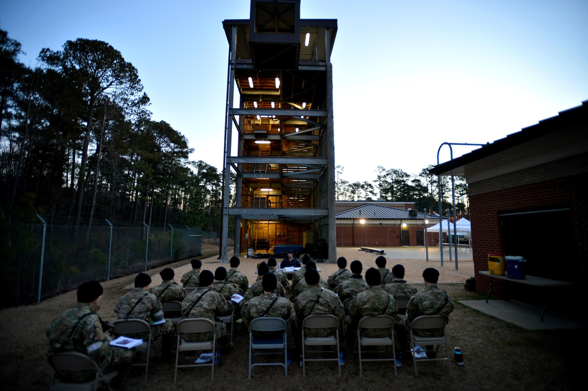 U.S. Air Force Combat Control trainees assigned to Operating Location C, 342nd Training Squadron, receive academic instruction prior to fast-rope training during a brisk winter morning, Feb. 13, 2015 at Pope Army Airfield, North Carolina. Academic instruction is a large part of fast-rope training for CCT students who are trying to learn and hone the skillset. (U.S. Air Force photo by Staff Sgt. Kenny Holston)    