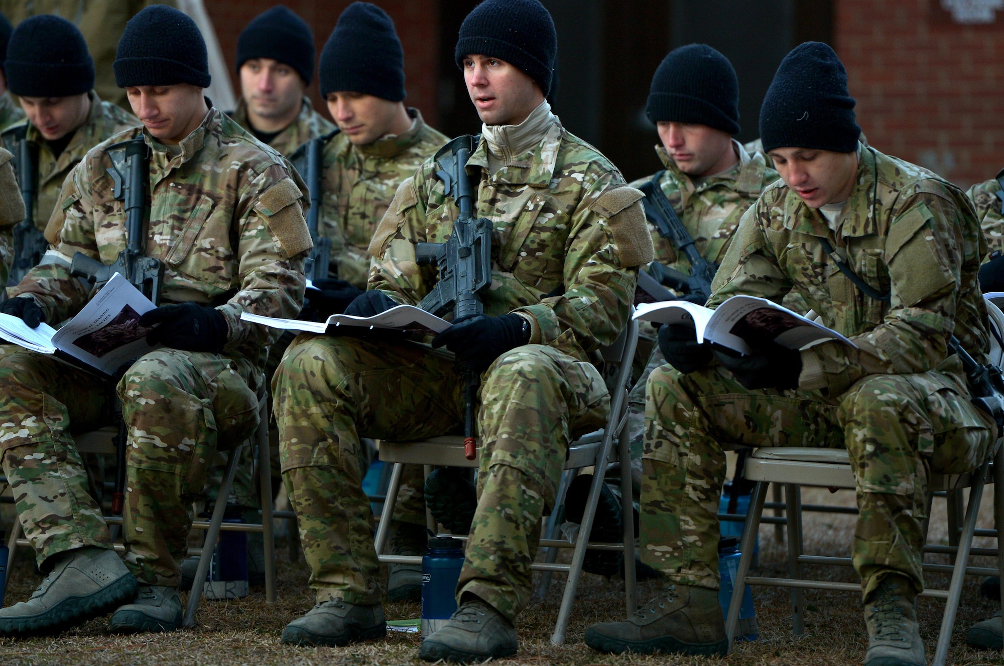 U.S. Air Force Combat Control trainees assigned to Operating Location C, 342nd Training Squadron, ask questions while receiving academic instruction prior to participating in fast-rope training on a cold winter morning, Feb. 13, 2015 at Pope Army Airfield, North Carolina. Academic instruction is a large part of fast-rope training for CCT students who are trying to learn and hone the skillset. (U.S. Air Force photo by Staff Sgt. Kenny Holston)   