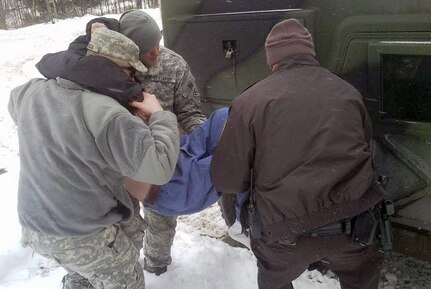 Soldiers with the Virginia Army National Guard assist a Wise County Sheriff’s Office deputy with transporting a Norton, Virginia, resident in need of medical treatment Feb. 23. Soldiers from the Virginia Army Guard have been on duty since Feb. 16 assisting local authorities as they respond to winter storms that dropped snow and ice throughout the region