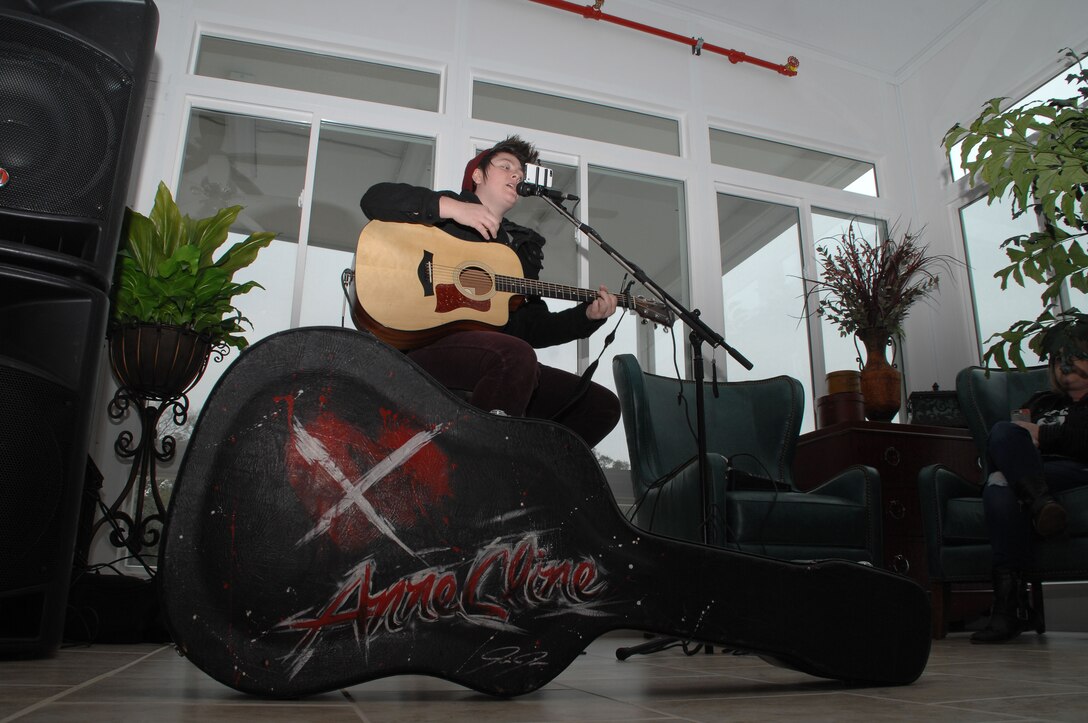 Anne Cline, a local singer and songwriter, provides live music during the grand opening of the Staff Noncommissioned Officers’ Lounge Sun Room, Feb. 20. 