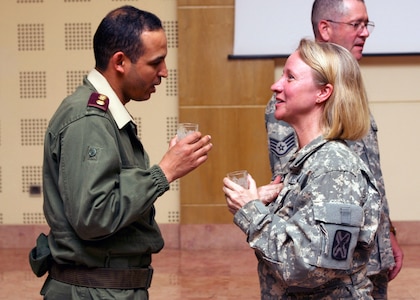 Staff Sgt. Anette Aldridge, a French linguist serving with Company C, 142nd Military Intelligence Battalion of the Utah Army National Guard, talks with a colonel of the Moroccan Army after a chemical awareness presentation given at the Moroccan military's South Command Headquarters in Agadir, May 16, 2010. Aldridge, along with other French and Arabic linguists of the 142nd MI Bn., were attached to the 151st Expeditionary Medical Group, Utah Air National Guard, to assist them as translators during humanitarian missions conducted as part of Exercise AFRICAN LION 2010.