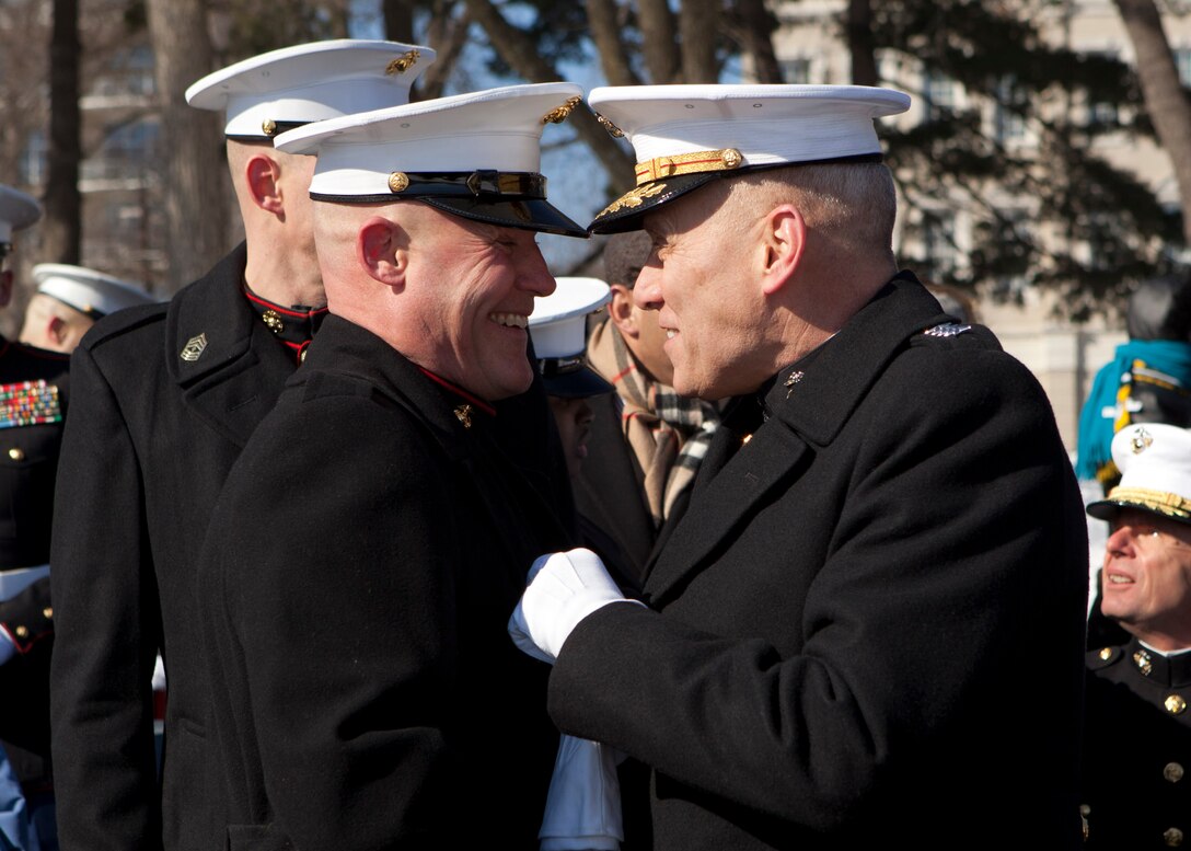 The Assistant Commandant of the Marine Corps, Gen. John M. Paxton, Jr., right, speaks with the 17th Sgt. Maj. of the Marine Corps, Sgt. Maj. Micheal P. Barrett, before the relief and appointment ceremony at the Marine Corps War Memorial, Arlington, Va., Feb. 20, 2015. (U.S. Marine Corps photo by Cpl. Tia Dufour/Released)