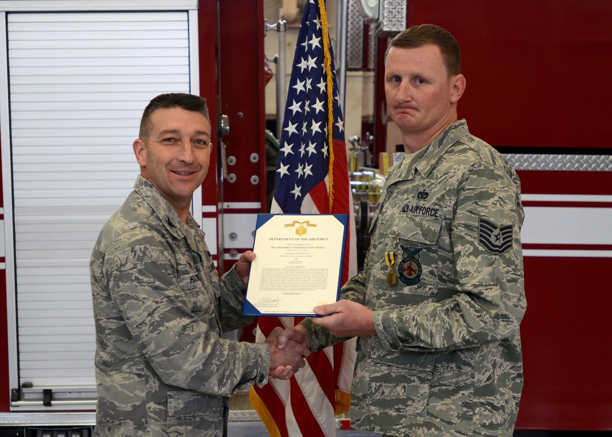 Tech. Sgt. Patrick Ogborn is presented an Air Force Commendation Medal by Col. Brian Hastings, 47th Flying Training Wing commander at Laughlin Air Force Base, Texas, Feb. 25, 2015. Ogborn's medal citation reads: Technical Sergeant Patrick L. Ogborn distinguished himself by an act of courage while assigned to the 47th Civil Engineer Squadron, 47th Mission Support Group, 47th Flying Training Wing, Laughlin Air Force Base, Texas.  On that date and while off-duty, Sergeant Ogborn rushed to the medical aid of a 35-year-old male active duty member who had collapsed in the fitness center while playing basketball.  His initial assessment determined the unconscious patient had no pulse and was not breathing. He immediately assisted with the administration of cardiopulmonary resuscitation, providing three sets of artificial ventilation and mouth-to-mouth breathing, delivering vital oxygen to the patient's lungs. Furthermore, Sergeant Ogborn aided in the prompt set-up and application of the automated external defibrillator, which assessed the patient as needing one shock.  After the shock was delivered, the patient regained circulation and started breathing. He then assisted with patient monitoring, stabilization and transfer to fire emergency services and advanced life support personnel for prompt transport to the nearest medical facility.  Sergeant Ogborn's unselfish and immediate measures directly contributed to aborting cardiac death and saving an Airman's life.  By his prompt action and humanitarian regard for his fellowman, Sergeant Ogborn has reflected credit upon himself and the United States Air Force. (U.S. Air Force photo by Staff Sgt. Steven Doty)