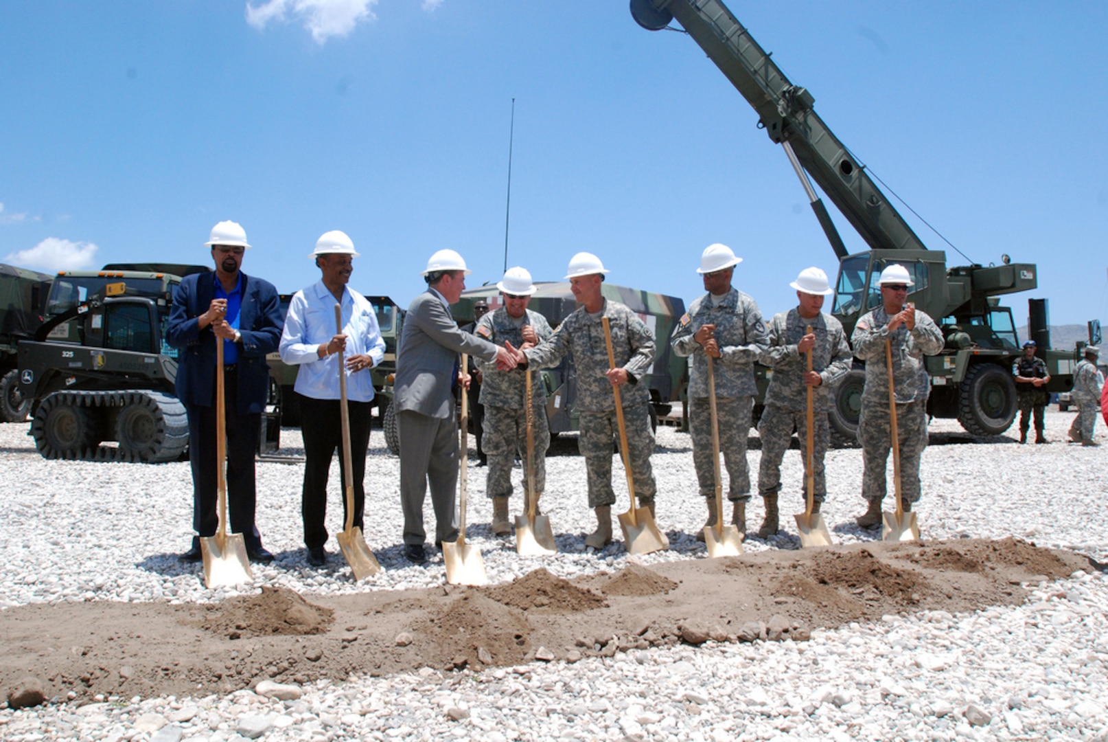 From left to right: Mr. Pierre Michele Laguerre, the director general of the Haiti Ministry of Education, Dr. Gabriel Timonthe, the director general of the Haiti Ministry of Public Health, Mr. David Lindwall, the deputy chief of mission, Army Maj. Gen. Bennett C. Landreneau, the adjutant general of Louisiana National Guard, Army Col. Michael J. Borrel, commander of Task Force Kout Men, Army Brig. Gen. Renaldo Rivera, the adjutant general of the Virgin Islands, Army Brig. Gen. Manuel Ortiz Jr., the deputy commanding general of the U.S. Army South, and Command Sgt. Maj. Tommy Callier, the senior enlisted advisor of the Louisiana National Guard, celebrate after the Task force Kout Men New Horizons 2010 opening ceremony June 15, 2010.