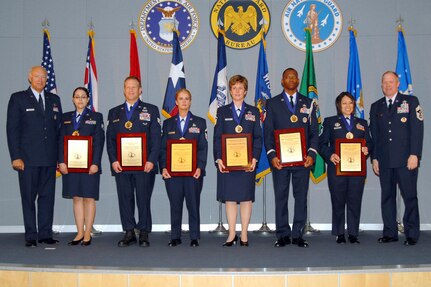 The Air National Guard’s six Outstanding Airmen of the Year hold their award plaques at the Air Guard’s Readiness Center on Joint Base Andrews during an award ceremony celebrating their accomplishments June 14, 2010.