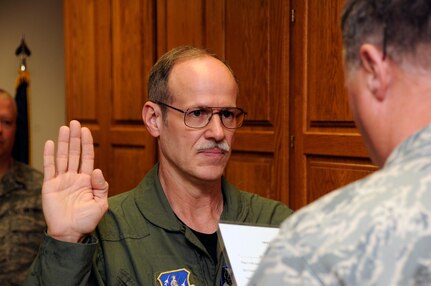 Dr. Glenn Harden, a physician from Sioux City, Iowa, is sworn into the Air National Guard at the 185th Air Refueling Wing on May 1, 2010. Harden will work as the flight surgeon at the 185th ARW medical clinic.