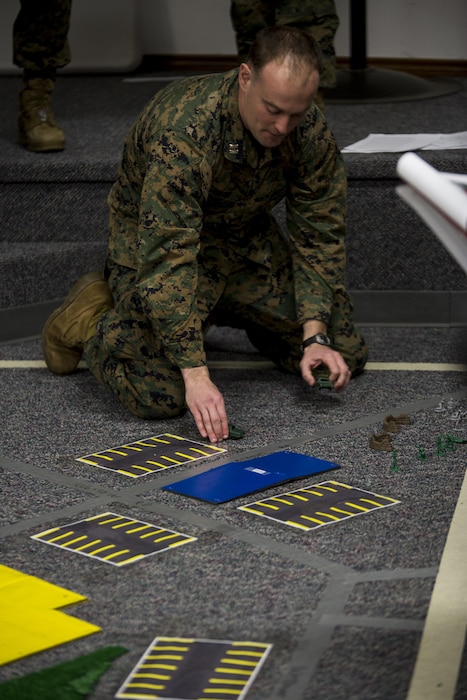 Capt. Joseph S. Hodges, antiterrorism force protection officer with Combat Logistics Regiment 4, 4th Marine Logistics Group, briefs Marines using a terrain map before a casualty evacuation drill during the Marine Expeditionary Force Exercise in Kansas City, Mo, Feb. 20, 2015. Reserve Marines acted as the regimental guard force for the exercise with I MEF to improve interoperability between the active and Reserve component, while preparing Marines with a realistic training environment at the force level. 