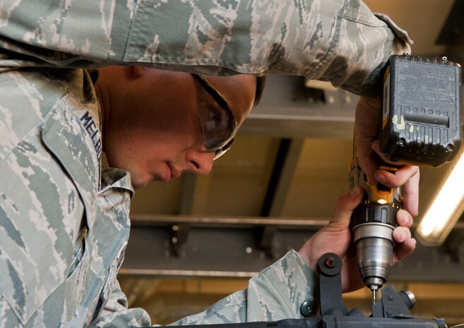Senior Airman Colby Melburn, 823rd Maintenance Squadron aircraft metals technology apprentice, removes a stuck screw from the tail rotor of an HH60G Pave Hawk at the 823rd MXS hangar on Nellis Air Force Base, Nev., Feb. 24, 2015. Pave Hawks have color-weather radar and an engine (rotor blade) anti-ice system that gives the HH-60G an adverse weather capability. (U.S. Air Force photo by Airman 1st Class Mikaley Towle)