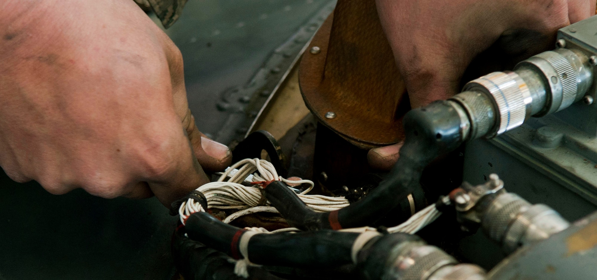 Senior Airman Rob Wainwright, 823rd Maintenance Squadron HH-60G Pave Hawk crew chief, performs maintenance on an electrical harness during the aircraft’s phase inspection at the 823rd MXS maintenance hangar on Nellis Air Force Base, Nev., Feb. 24, 2015. The 823rd MXS is responsible for the maintenance and upkeep of all the HH-60Gs assigned to Nellis AFB. (U.S. Air Force photo by Airman 1st Class Mikaley Towle)