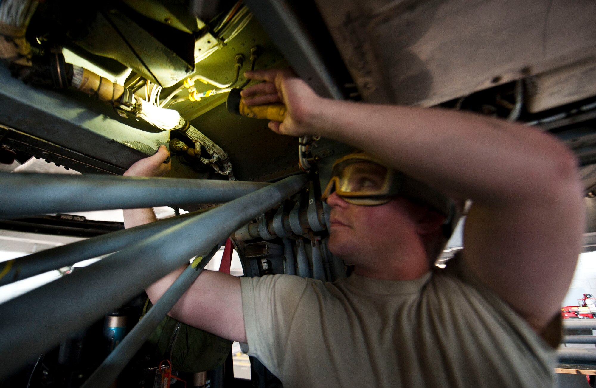 Senior Airman Dylan Abraham, 823rd Maintenance Squadron HH-60G Pave Hawk crew chief, performs maintenance on an HH-60G during the aircraft’s phase inspection at the 823rd MXS maintenance hangar on Nellis Air Force Base, Nev., Feb. 24, 2015. The 823rd MXS is responsible for rapidly mobilizing and deploying forces to provide combat and peacetime search and rescue operations in support of national security interests. (U.S. Air Force photo by Senior Airman Thomas Spangler)