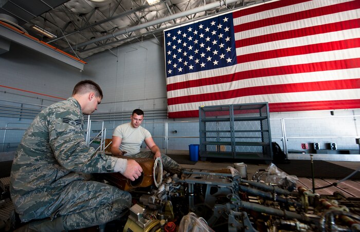 Senior Airmen Thomas Crawford (left) and Rob Wainwright, 823rd Maintenance Squadron HH-60G Pave Hawk crew chiefs, re-install a heating duct on an HH-60G during the aircraft’s phase inspection at the 823rd MXS maintenance hangar on Nellis Air Force Base, Nev., Feb. 24, 2015. The mission of the 823rd MXS is to maintain, service and inspect HH-60G aircraft. (U.S. Air Force photo by Senior Airman Thomas Spangler)
