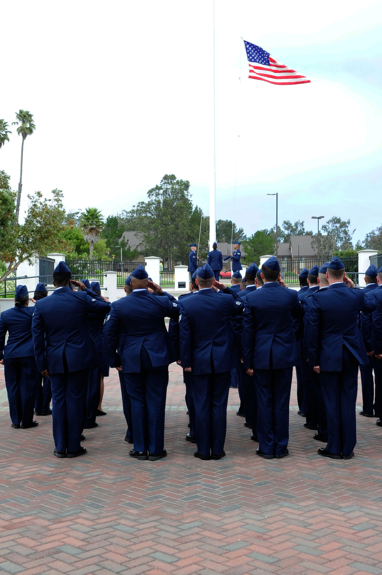 The 30th Space Wing Staff Agencies perform a Retreat ceremony in front of the Wing Headquarters building, Aug. 31, 2014, Vandenberg Air Force Base, Calif. Retreat is the ceremony for securing the American flag, and signals the end of the duty day while providing an opportunity to pay respect to the flag; beginning March 1, Retreat will play at 5 p.m. with Reveille played at 7 a.m. (U.S. Air Force photo by Tech. Sgt. Tyrona Lawson/Released)
