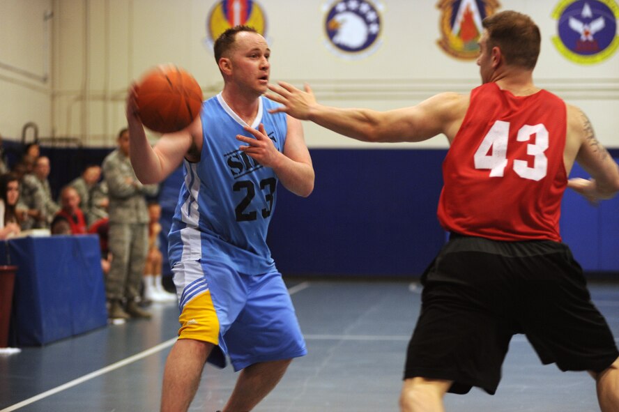Space Innovation and Development Center co-captain Shawn Green looks for a passing lane during the second half of the intramural basketball championship game in the fitness center on Feb. 19. SIDC defeated 3rd Space Operations Squadron 54-44 to win the title and finish the season undefeated. (U.S. Air Force photo/Dennis Rogers)