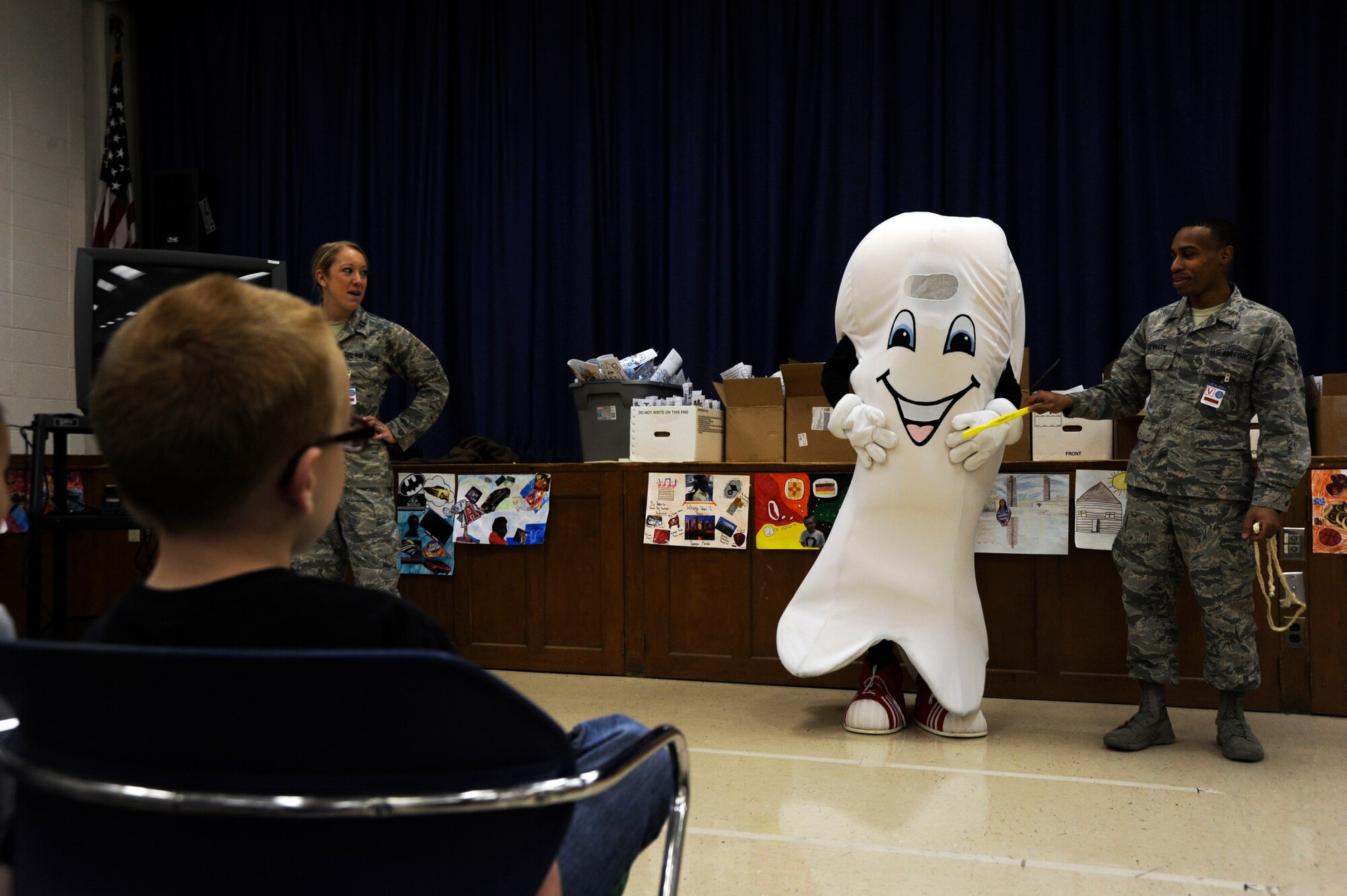 Capt. Cassidy Mennen, 42nd Aeromedical Medicine Squadron general dentist, and Airman 1st Class Andreus Denmark, 42nd AMDS dental technician, teach kindergarten students from Maxwell Elementary-Middle School the importance of dental hygiene with 42nd AMDS mascot Maj. Molar. The Airmen visited the school in response to February being designated as Children’s Dental Health Month. (U.S. Air Force photo by Airman 1st Class Alexa Culbert/Cleared)
