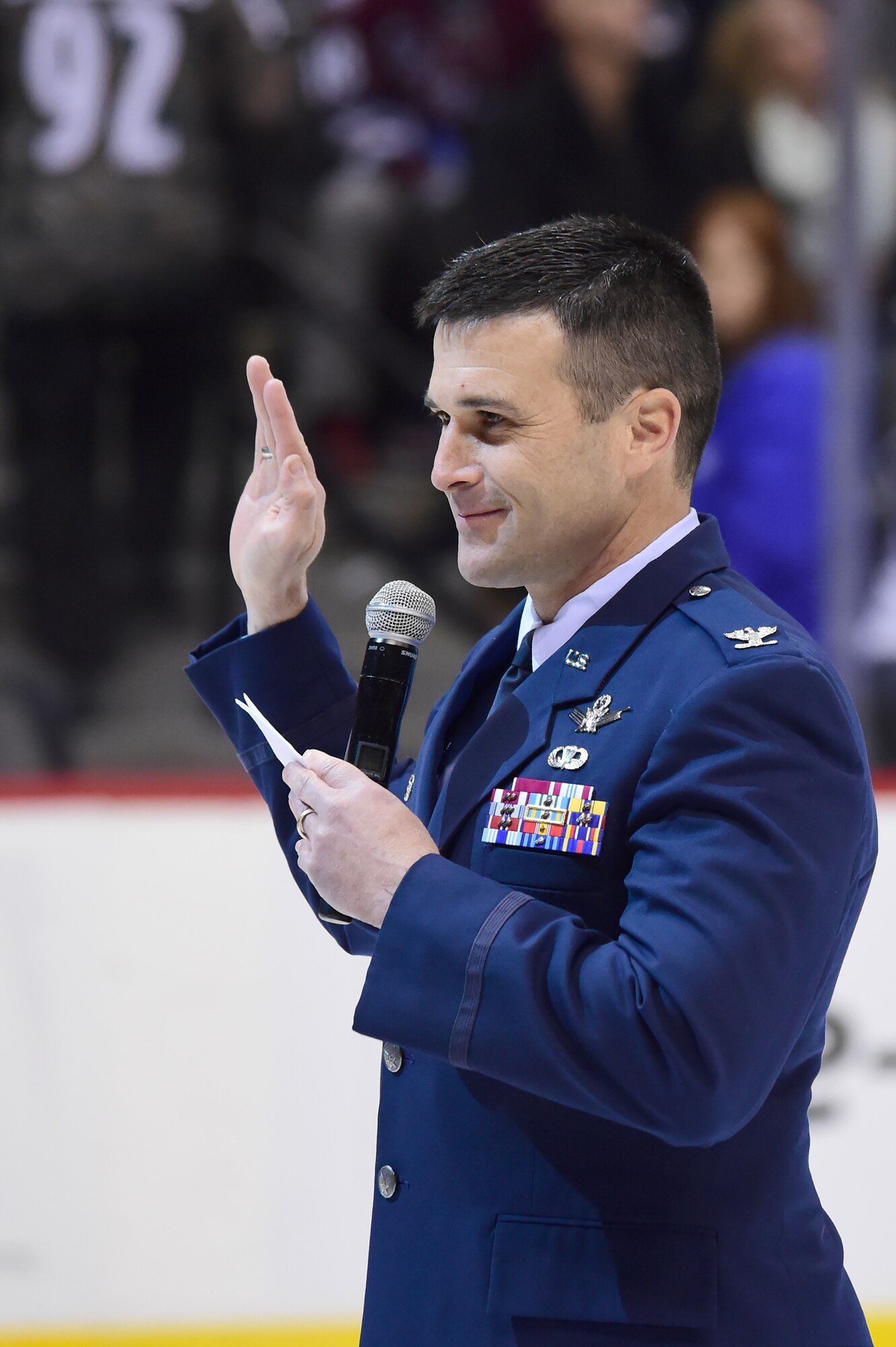 Col. John Wagner, 460th Space Wing commander, administers the Oath of Enlistment to military recruits during a military appreciation night Feb. 22, 2015, at the Pepsi Center in Denver. The 18 military recruits represented all military branches. (U.S. Air Force photo by Airman 1st Class Luke W. Nowakowski/Released)