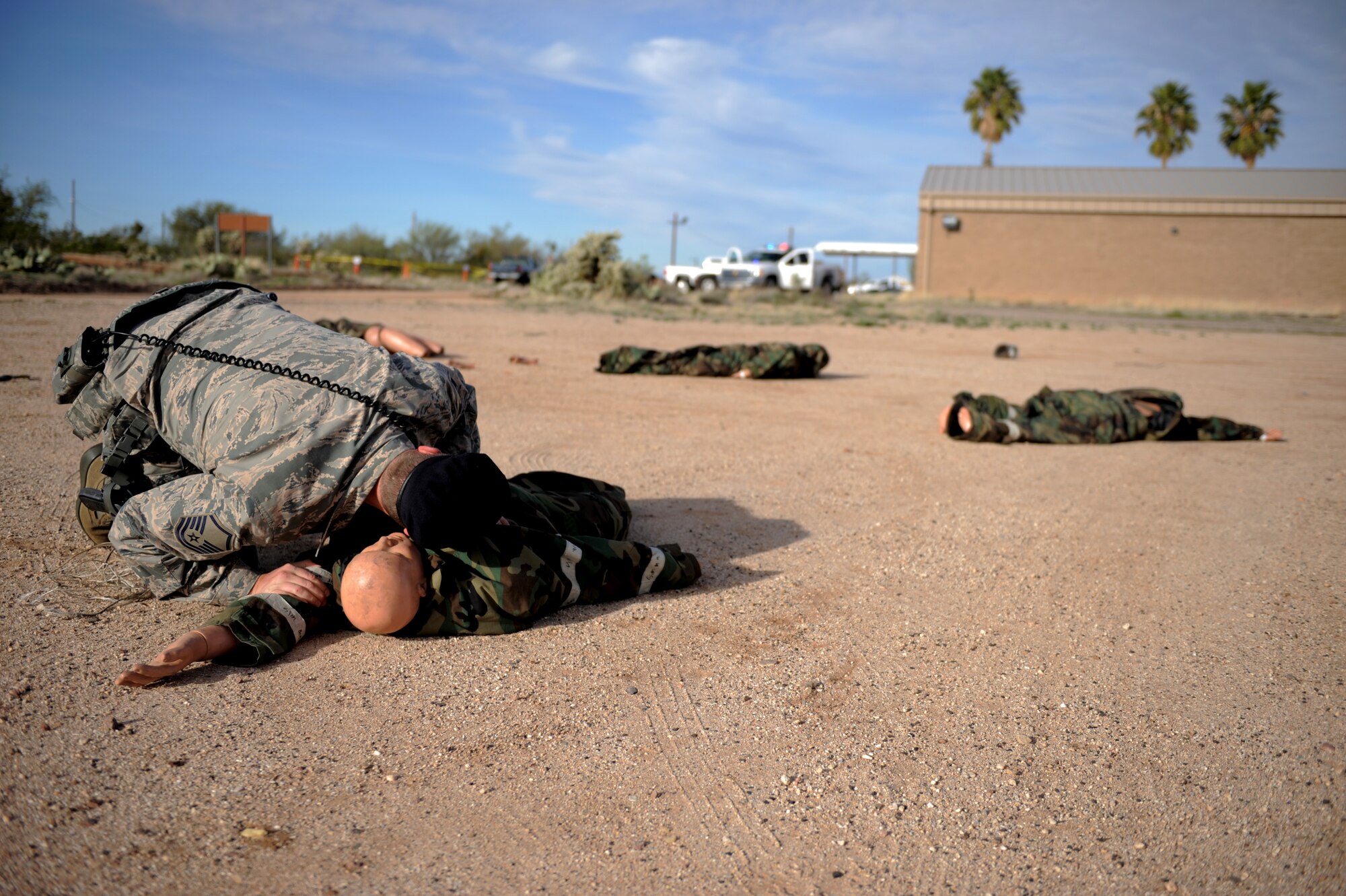 A U.S. Air Force Airman from the 355th Security Forces Squadron checks a simulated casualty’s breathing during an aircraft crash exercise at Davis-Monthan Air Force Base, Ariz., Feb. 19, 2015. The exercise was held to test D-M’s capabilities to respond to an aircraft crash incident with mass-casualties. (U.S. Air Force photo by Airman 1st Class Chris Drzazgowski/Released)