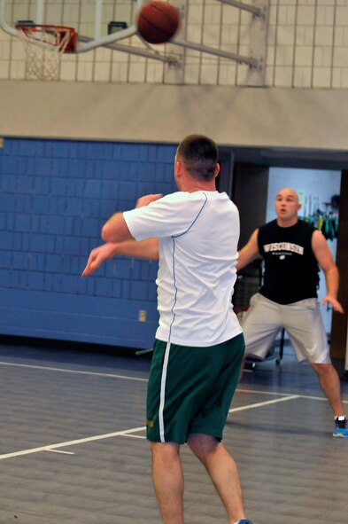 MCGHEE TYSON AIR NATIONAL GUARD BASE, Tenn. - Master Sgt. Jerry Harlan passes the basketball toward the basket. Airmen and civilian staff from all three divisions at the I.G. Brown Training and Education Center joined at Wilson Hall here Feb. 25 for a basketball game. (U.S. Air National Guard photo by Master Sgt. Mike R. Smith/Released)