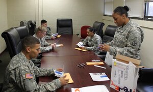U.S. Army Spc. Ashley Saahir, 688th Rapid Port Opening Element, 597th Transportation Brigade information technology specialist, near right, registers 688th RPOE Soldiers into the Department of Defense’s C.W. Bill Young Bone Marrow Program at Fort Eustis, Va., Jan. 30, 2015. The program, also known as the DoD Marrow Donner Program and Salute to Life, matches potential donors with thousands of patients with life-threatening diseases waiting for bone marrow transplants. (U.S. Army photo by Loran Doane/Released)