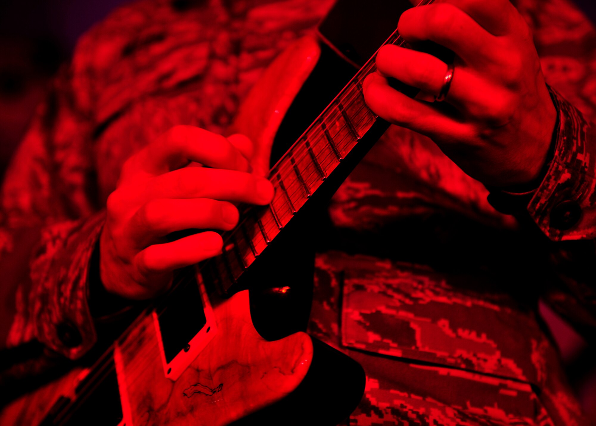 U.S. Air Force Staff Sgt. Aaron Weibe, U.S. Air Force Heritage of America band, the Blue Aces, guitarist, plays the guitar during a musical performance at Langley Air Force Base, Va., Feb. 12, 2015. All members of the Blue Aces have musical backgrounds and strive to support the morale and welfare of Airmen and combined forces deployed across the globe. (U.S. Air Force photo by Airman 1st Class Breonna Veal/Released)