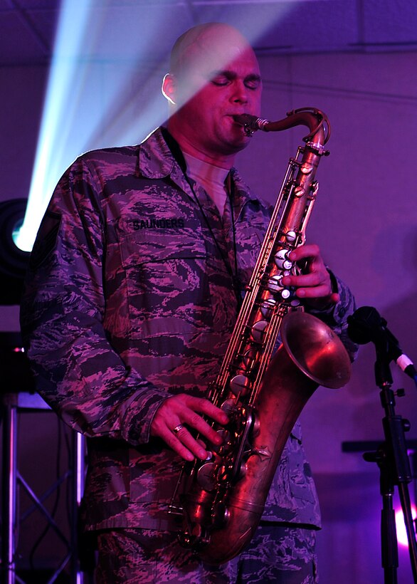 U.S. Air Force Master Sgt. Jeff Saunders, Heritage of America Band Blue Aces, member, plays the saxophone during a musical performance at Langley Air Force Base, Va., Feb. 12, 2015. The Blue Aces perform annually for many military and civilian audiences, in places ranging from small official dinners to large festival events. (U.S. Air Force photo by Airman 1st Class Breonna Veal/Released)