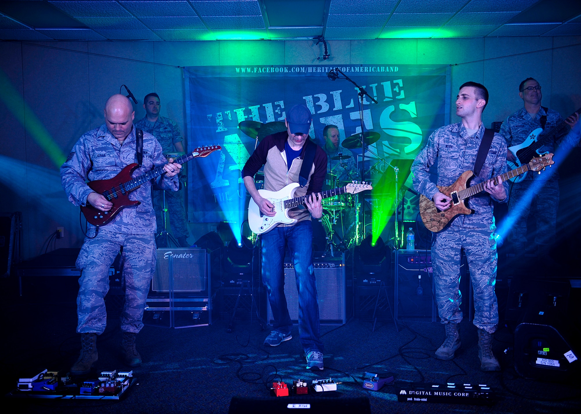 The Blue Aces, a component of the U.S. Air Force Heritage of America Band, perform with Jake Cinninger, Umphrey’s McGee’s lead guitarist, during a musical performance at Langley Air Force Base, Va., Feb. 12, 2015. Cinninger, an American musician, has been playing musical instruments since he was 3 years old. (U.S. Air Force photo by Airman 1st Class Breonna Veal/Released)