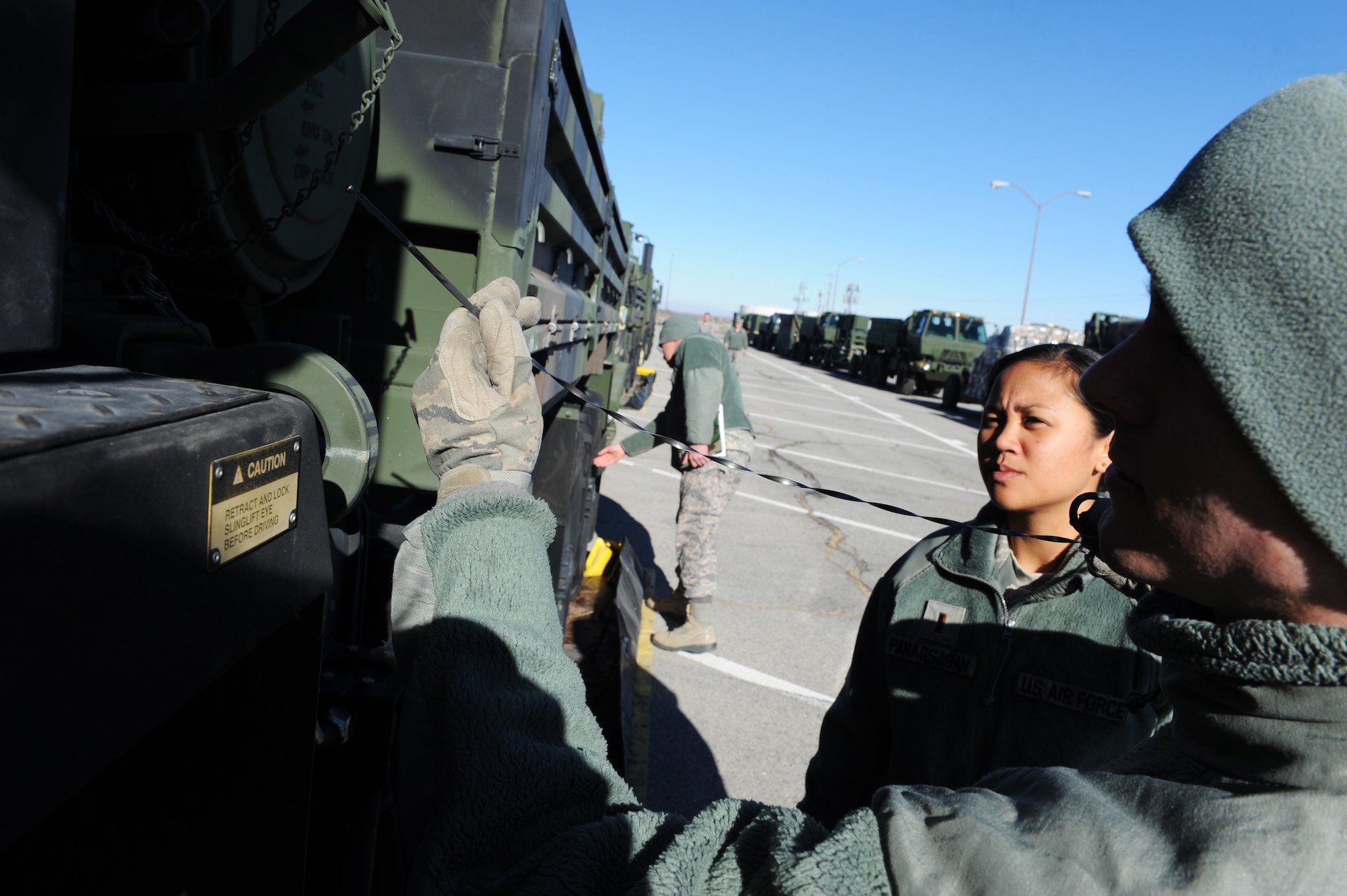 Members of the the 729th Air Control Squadron departed for the Red Flag 15-2 exercise at Nellis AFB, Nev., recently with a convoy of dozens of vehicles. The “Angry Warriors” went to provide command and control support for the multi-national, joint-service exercise. Red Flag is a realistic combat training exercise involving the air, space, and cyber forces of the United States and its allies. The exercise is hosted north of Las Vegas on the Nevada Test and Training Range. 2nd Lt. Kim Pnagsagan, Airman 1st Class Trevor Beattie and Senior Airman Johnathan Pearson perform routine maintenance on their vehicle before departing.  (U.S. Air Force/Micah Garbarino)
