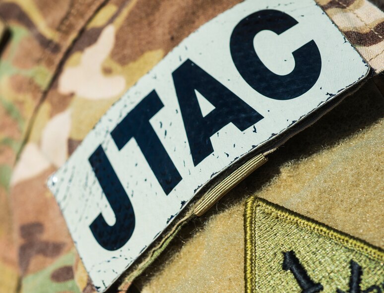 A joint terminal attack controller patch rests on the arm of U.S. Air Force Tech. Sgt. Clay Eckstrom, 7th Air Support Operations Squadron JTAC out of Fort Bliss, Texas, during a light air support training Feb. 20, 2015, at Moody Air Force Base, Ga. JTACs communicate with the pilots from the ground to direct the airstrikes. (U.S. Air Force photo by Airman 1st Class Ceaira Tinsley/Released) 